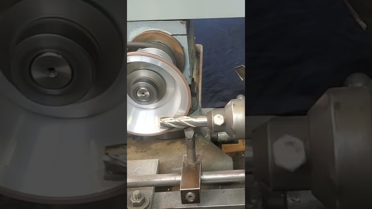 guy sharpening an endmill on tool sharpener with treadmill motor on it
