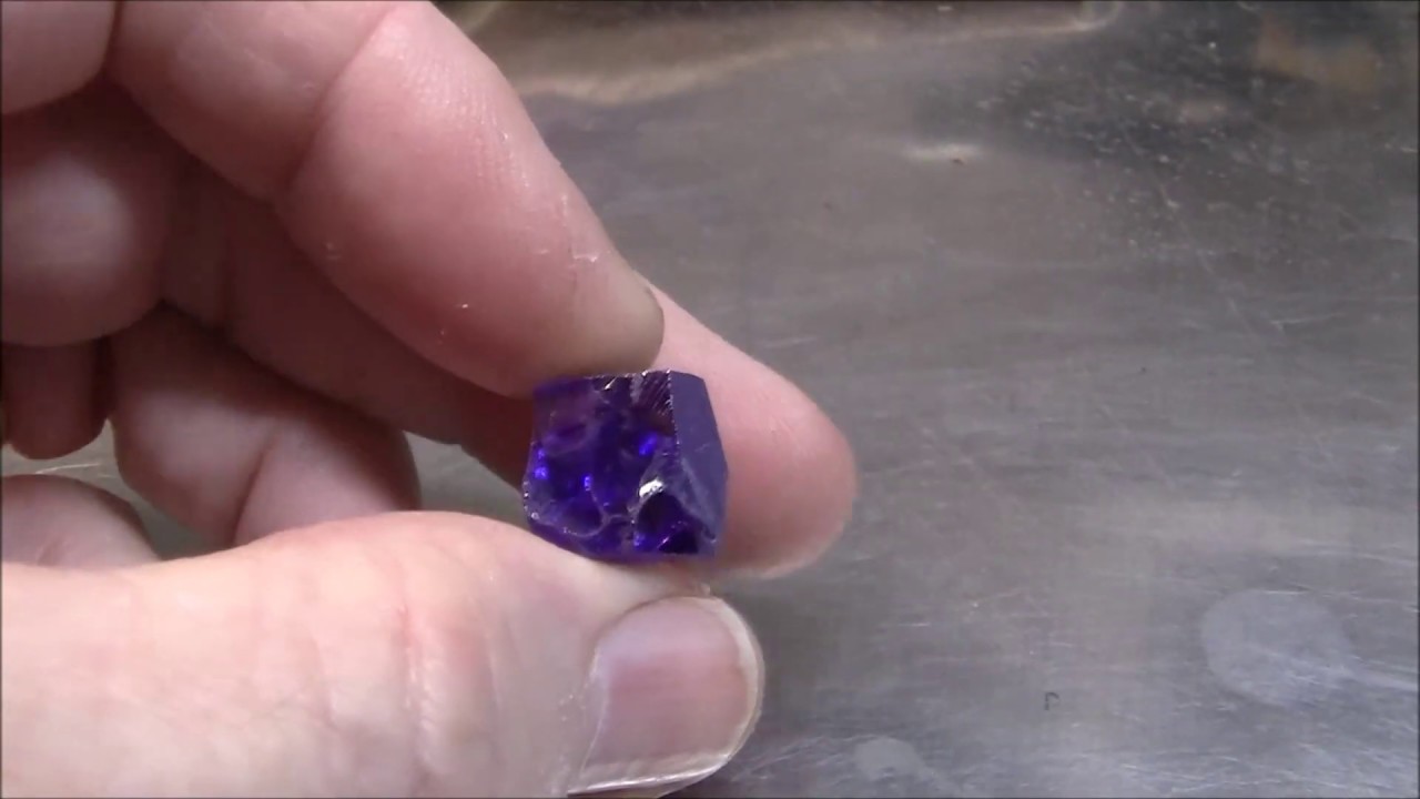 Faceting a gemstone: amethyst  cubic zirconia.