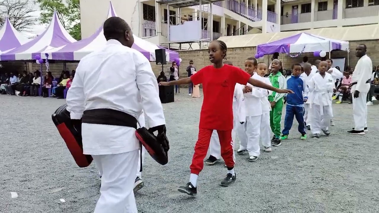 Tomylee - Kenya Karate Coach  presenting with kids At Good testimony junior school in career day.