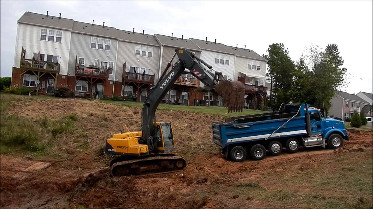 Loading Dump Trucks With Mud