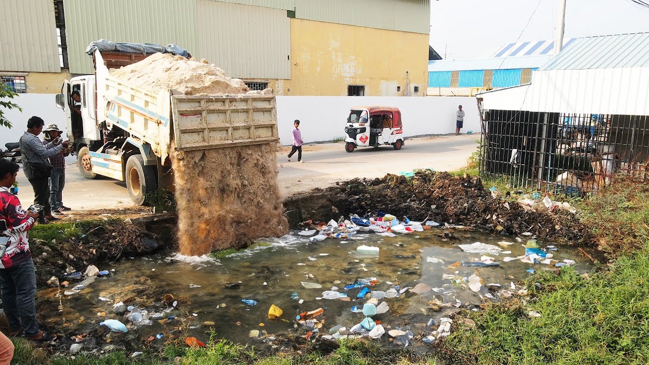 Amzing Work! Turn Down the garbage land and flood to the cleanly site by Bulldozer and Many Trucks