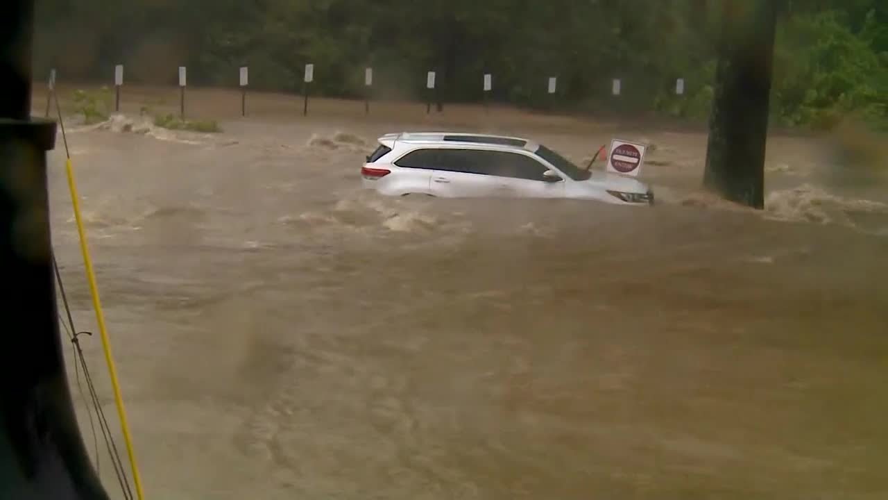 Video shows car being swept away by flood waters in Asheville, North Carolina