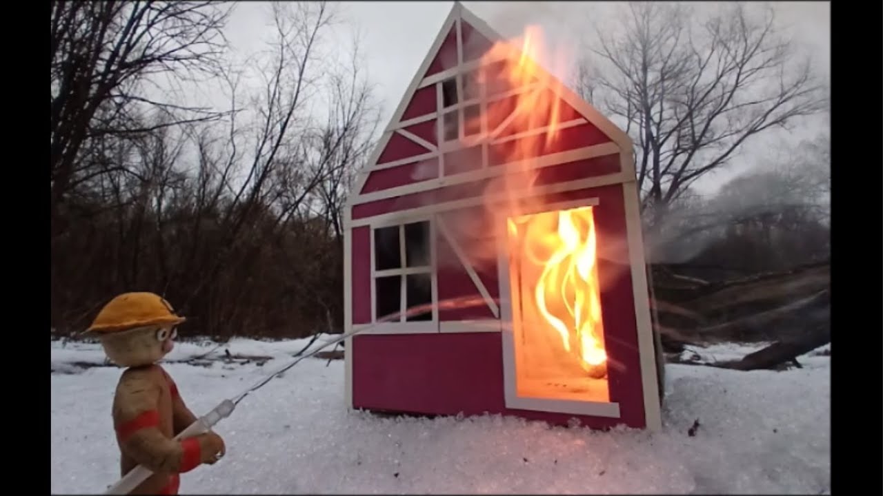 Extinguishing a fire in a dollhouse. A fireman's figurine made of plasticine