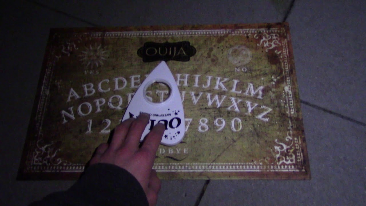 Using A Ouija Board In A Graveyard On Halloween Night