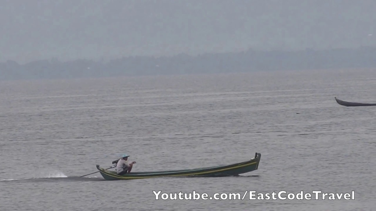 indawgyi lake morning mist and longtail boat