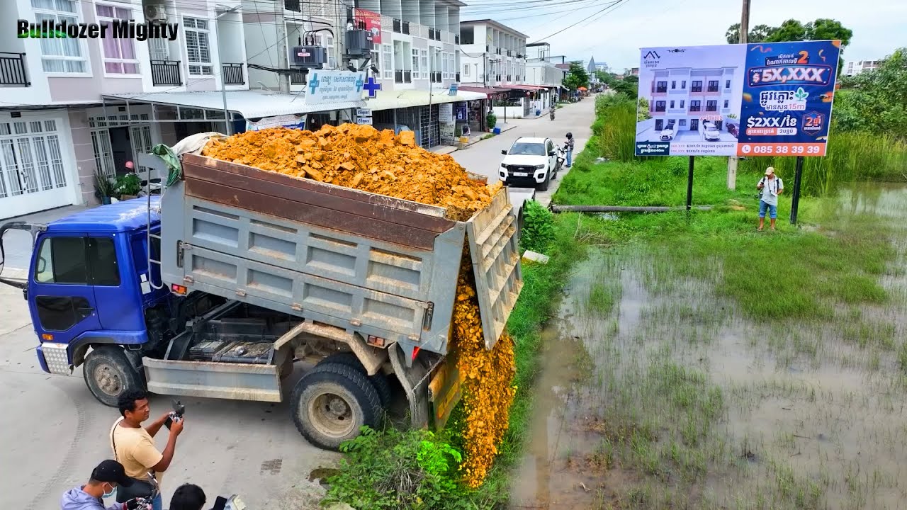 Bulldozer KOMATSU D31P Work, Filling Up The Land, Dump Truck