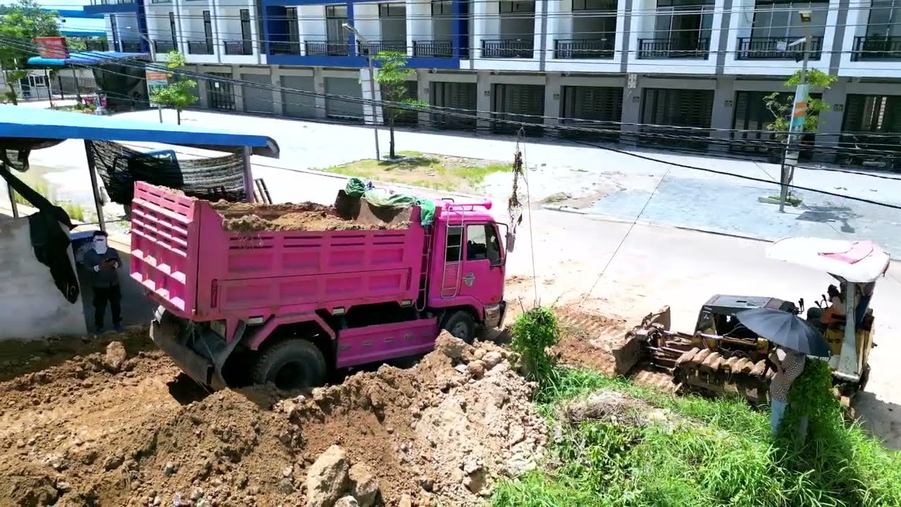 Fill Dirt into a Flooded Land Property to Same Road Level :  Bulldozer Komatsu D21P at work