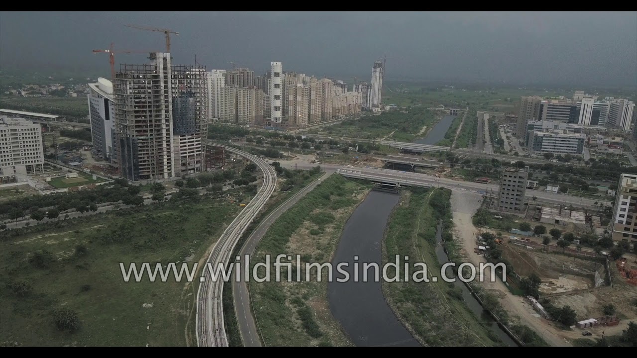 Aerials of Noida in cloudy weather - Delhi NCR suburb across the Yamuna river