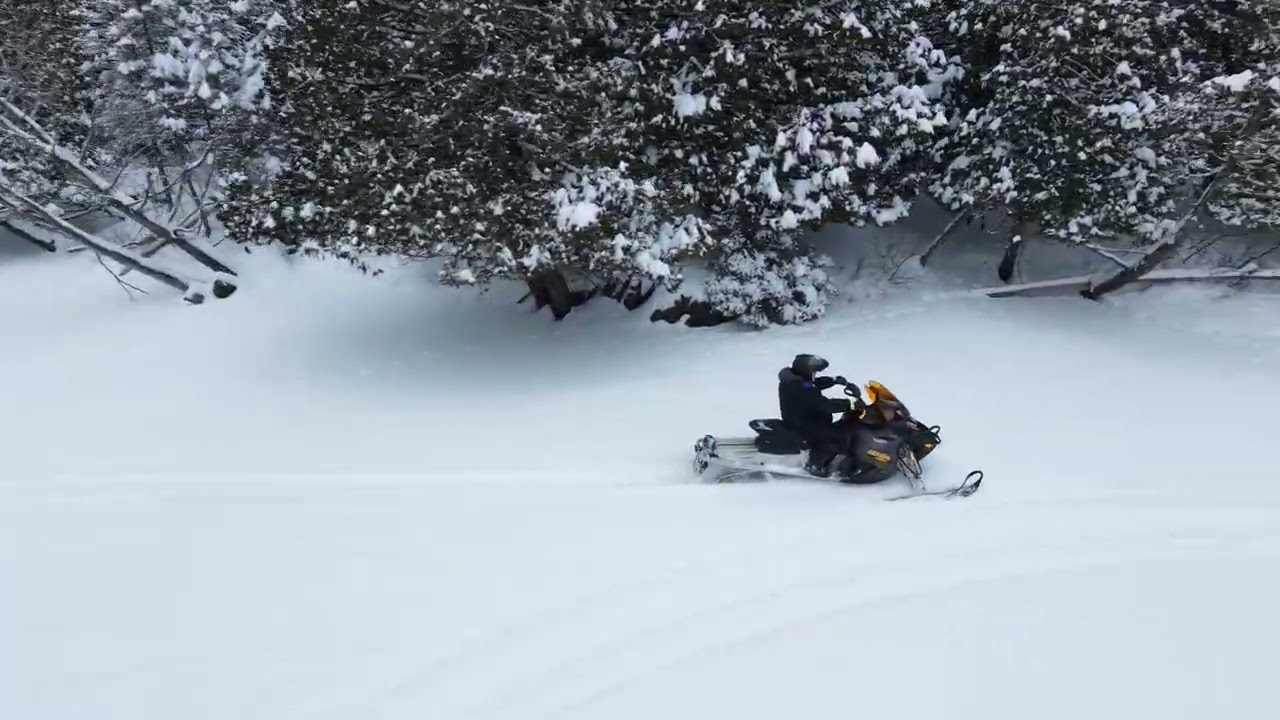 Neo 2 Following Snowmobile On Frozen River