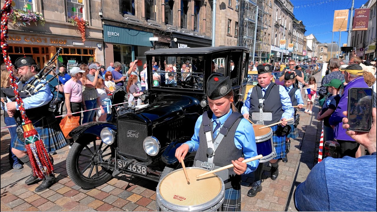 City of Inverness Youth Pipe Band march in 2025 Inverness Classic Vehicle Show parade in Scotland
