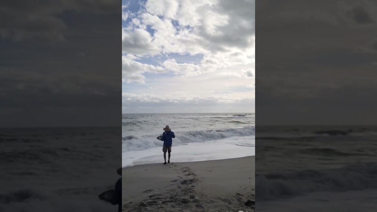 Giant redfish catch and release at Melbourne Beach in topical storm conditions, tight lines!