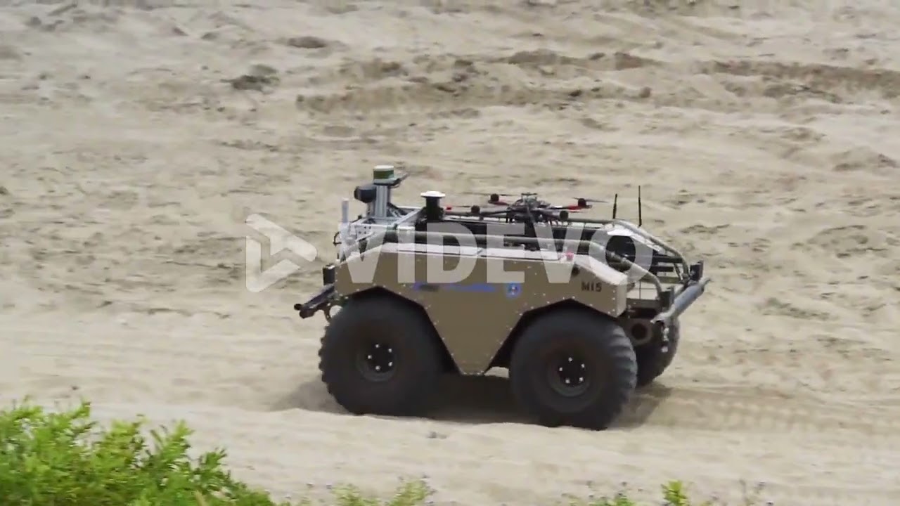 A Remote Controlled Tank Carries A Small Drone On Its Back In A Military Maneuver