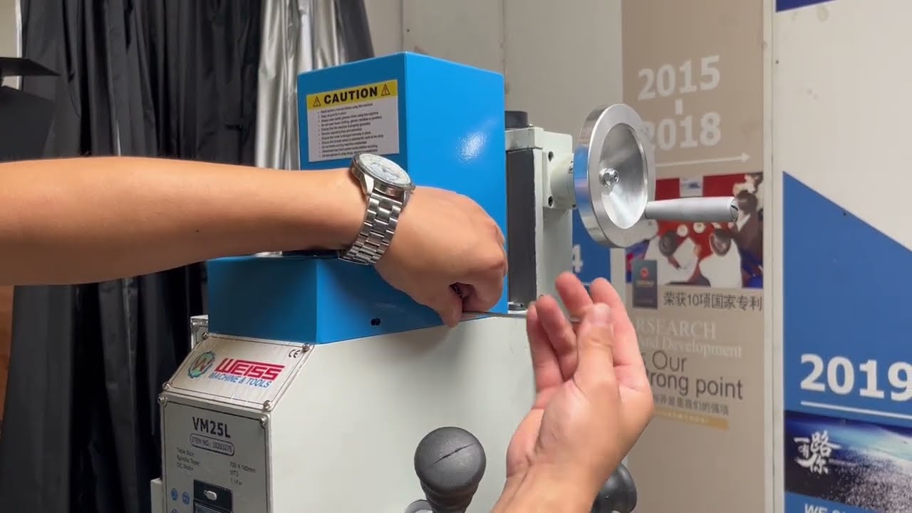 How to change the belt on a WEISS VM series milling machine using the VM25L machine as an example