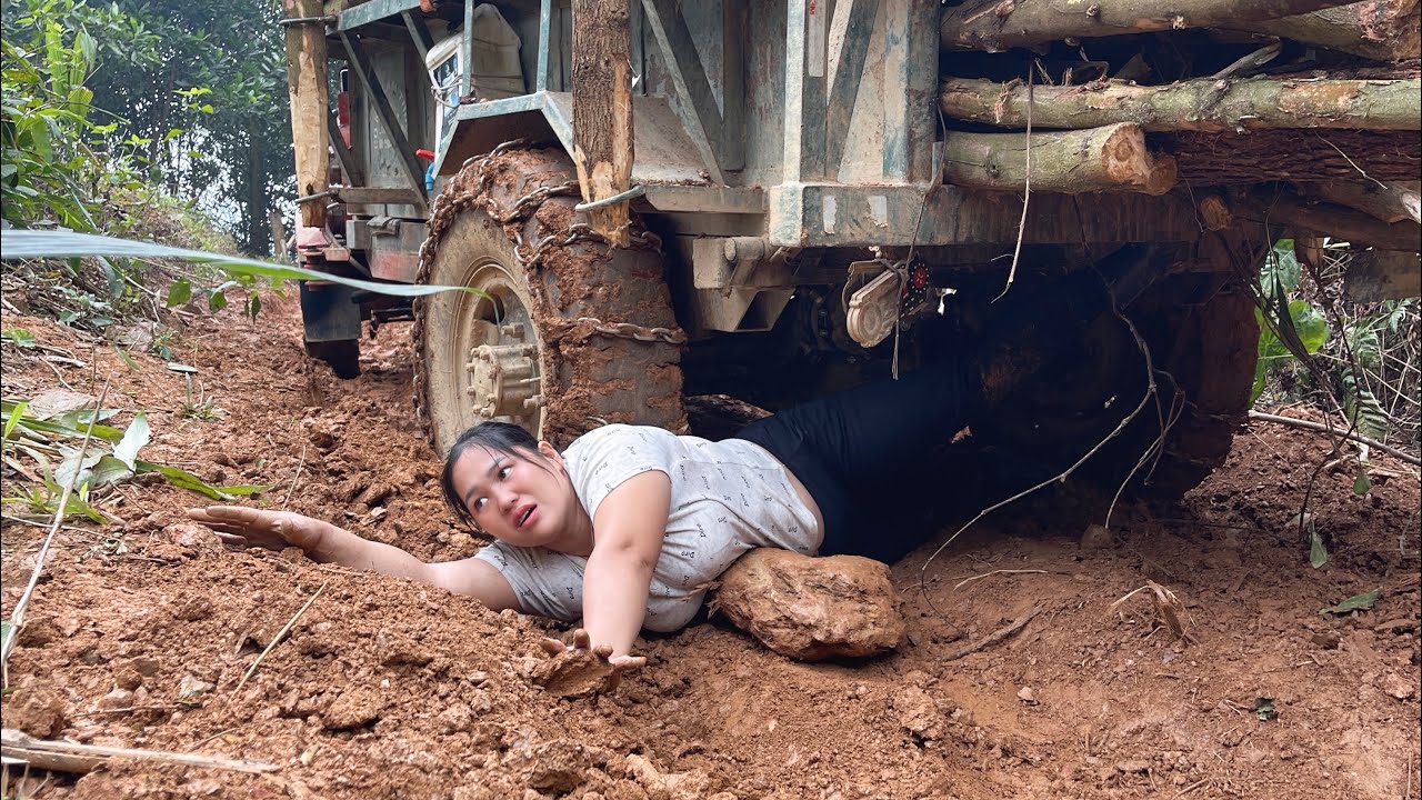 Transporting wood on a steep road in a farm vehicle is extremely dangerous for the girl.