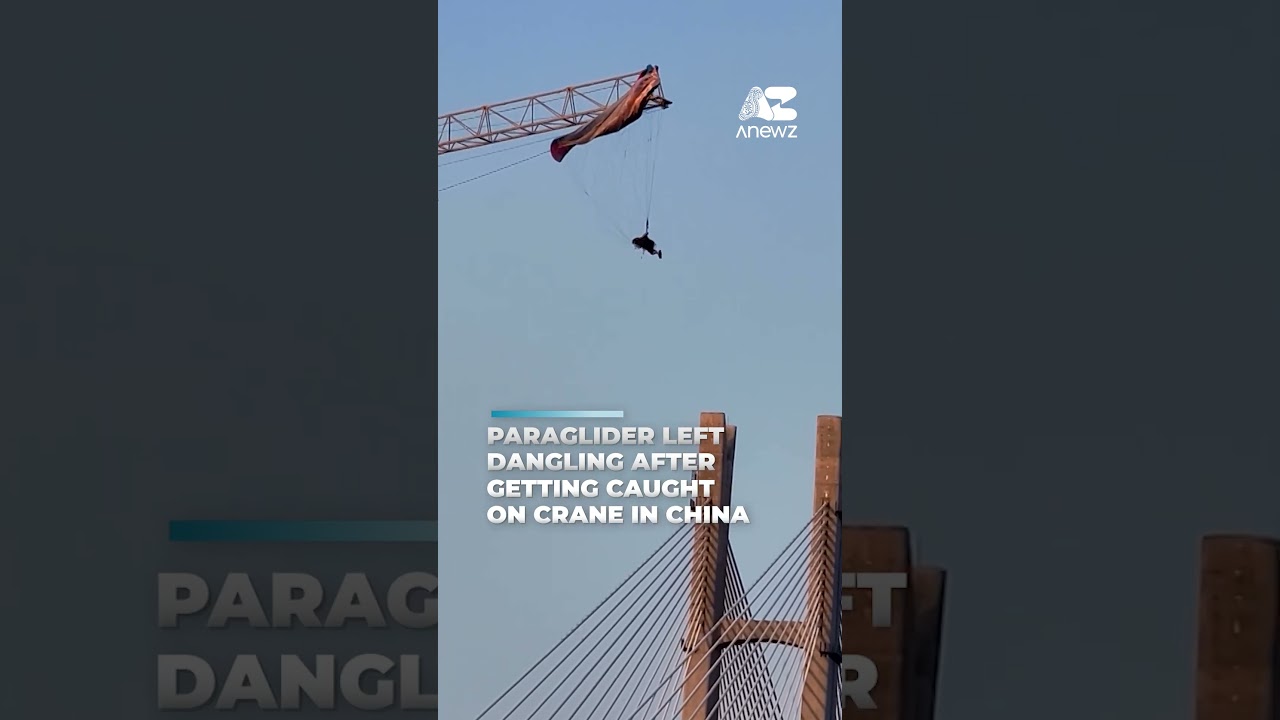 Paraglider left dangling after getting caught on crane in China