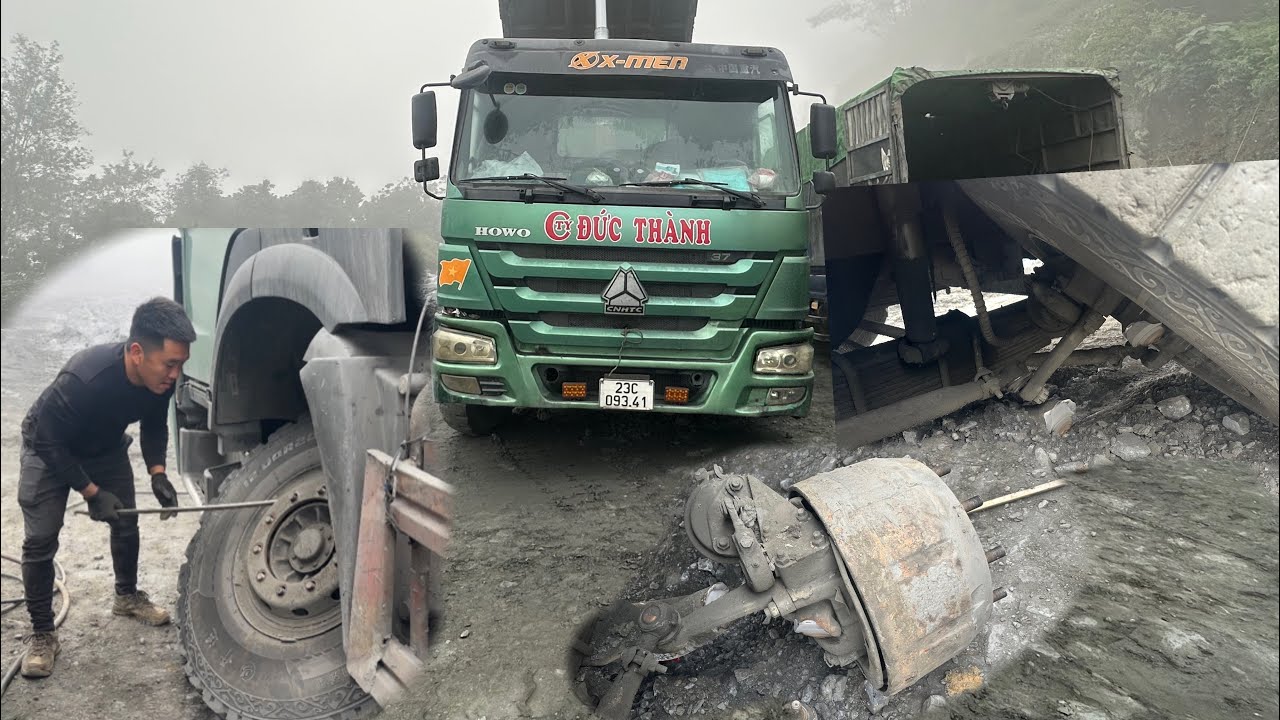 Rescue workers repair a dump truck with a broken front axle at a construction site in the mountains.
