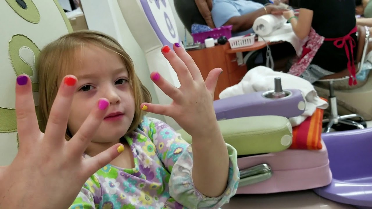 little girl getting nails done toes and fingers