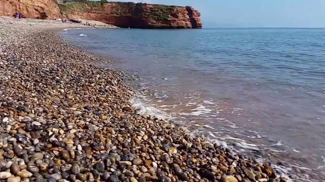 Relaxing sounds of Ladram Bay waves lapping on shingle beach