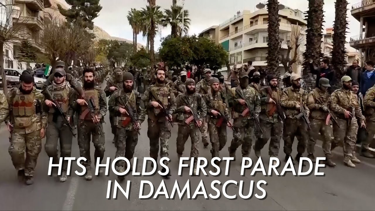 Militants, masks and missiles - Hay'at Tahrir al-Sham holds first parade since taking power in Syria