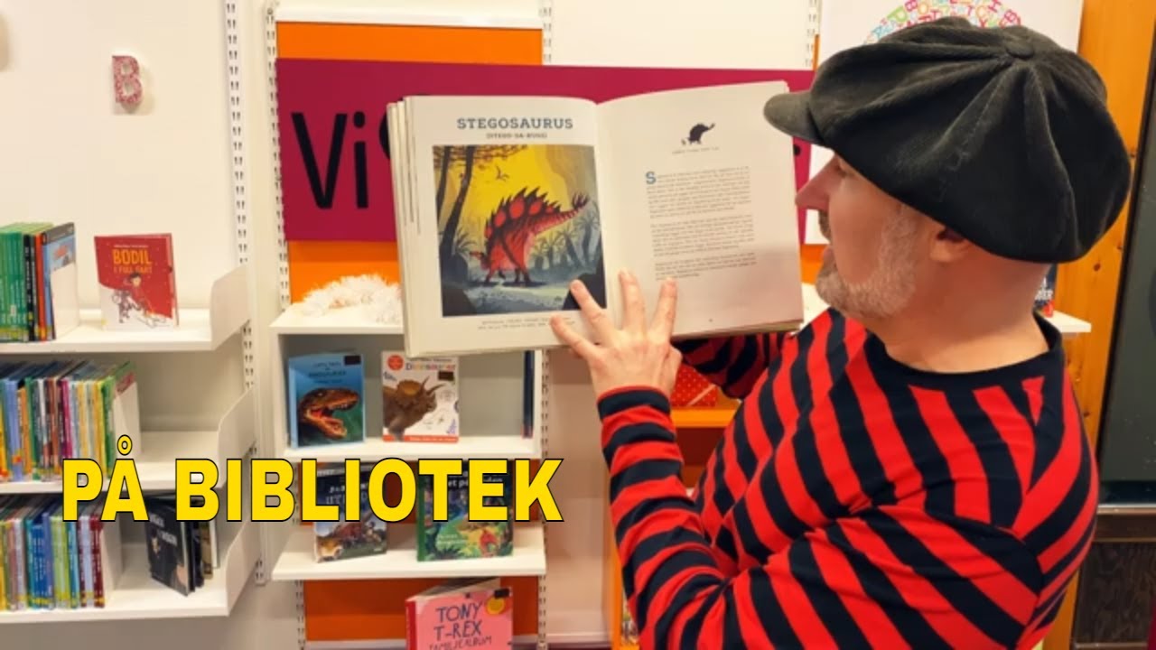 Dinosaurieböcker på bibliotek med Pappa Kapsyl