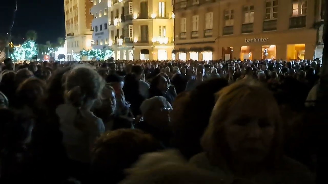 Crowed streets in Malaga enjoying Light show.