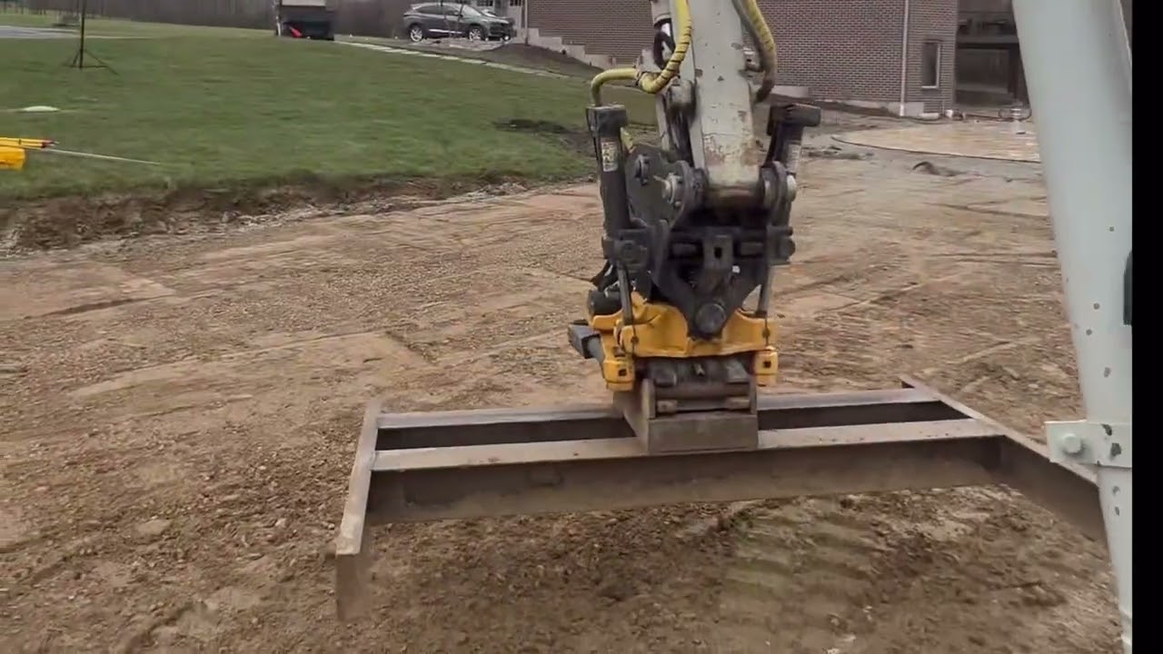 Final trim on a pad using grade beam on engcon tilt rotator and Trimble 2d earthworks