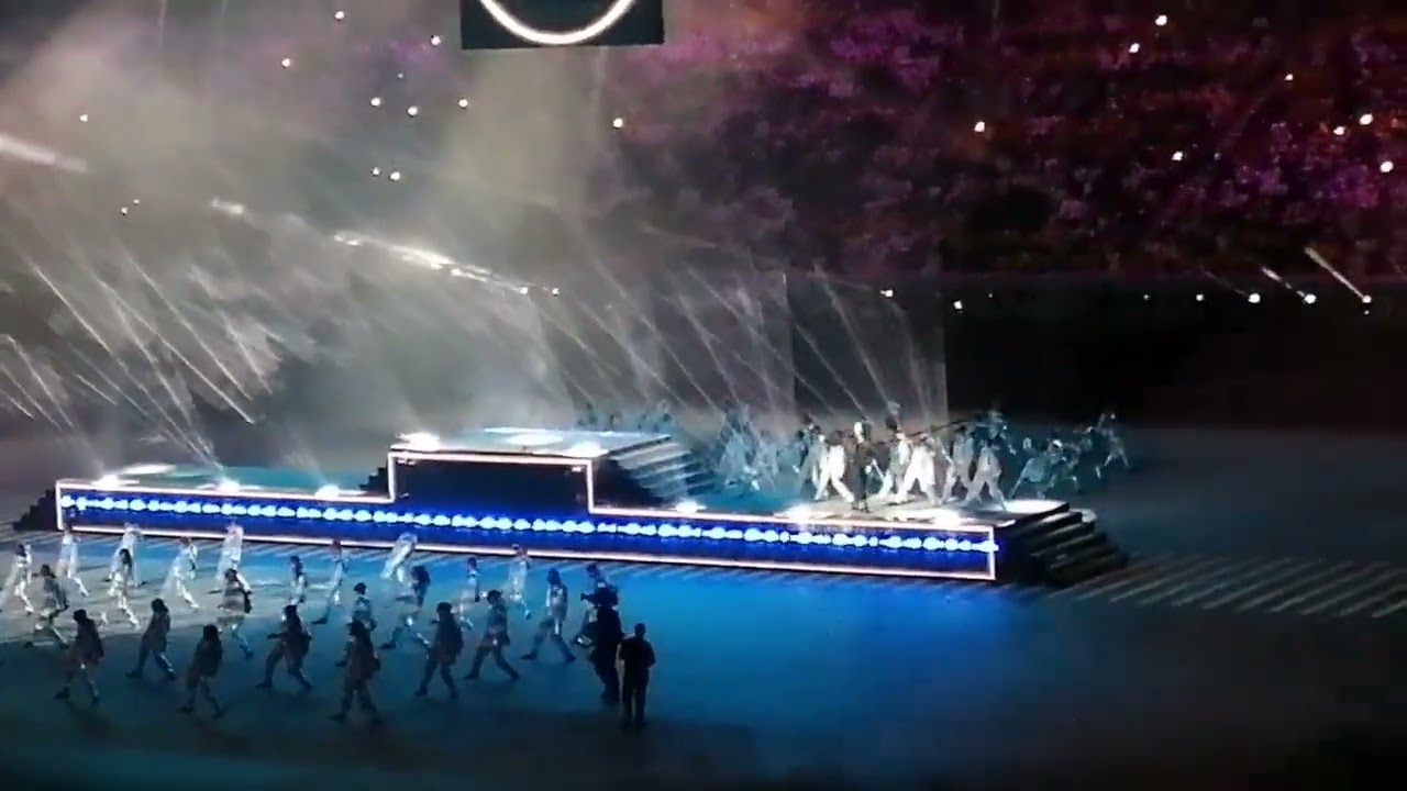 Jung Kook performing (Dreamers) with La'eeb mascot at the opening ceremony of the FIFA World Cup