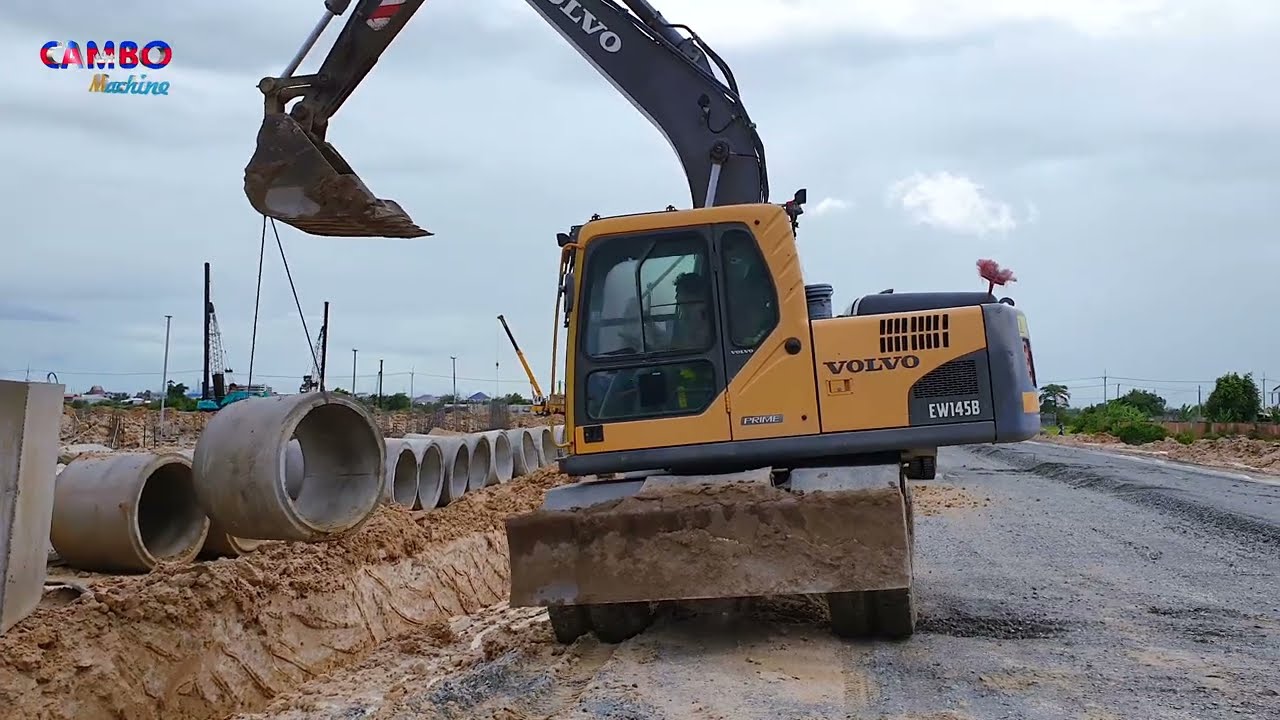 Wheel Excavator VOLVO EW145B at working make drainage system for building apartment project
