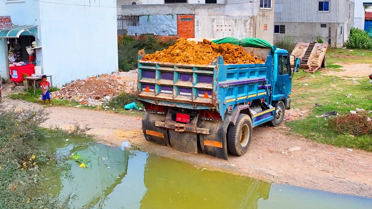 wonderful landfill project , truck transport soil , bulldozer push soil build house develop village