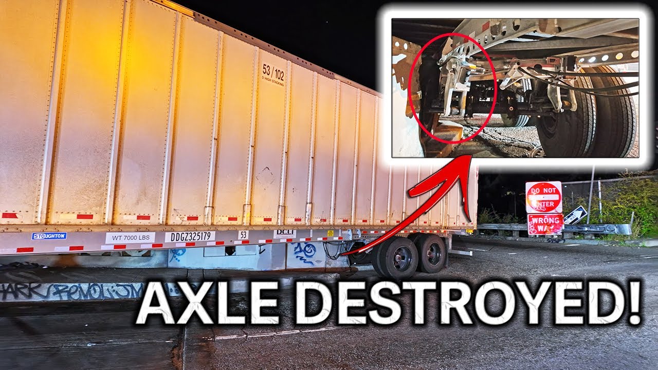Semi takes out light pole - destroys rear axle