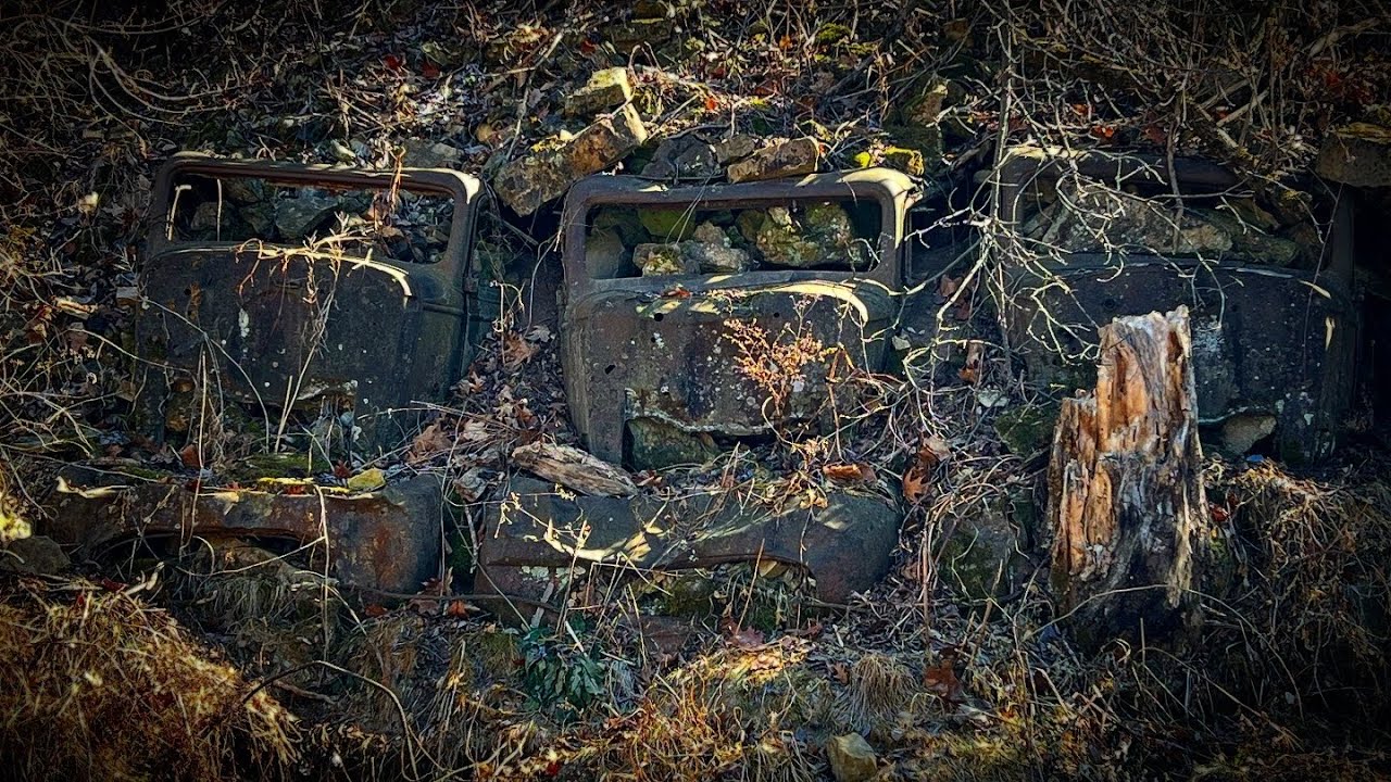 Abandoned Cars Buried into the Hillside