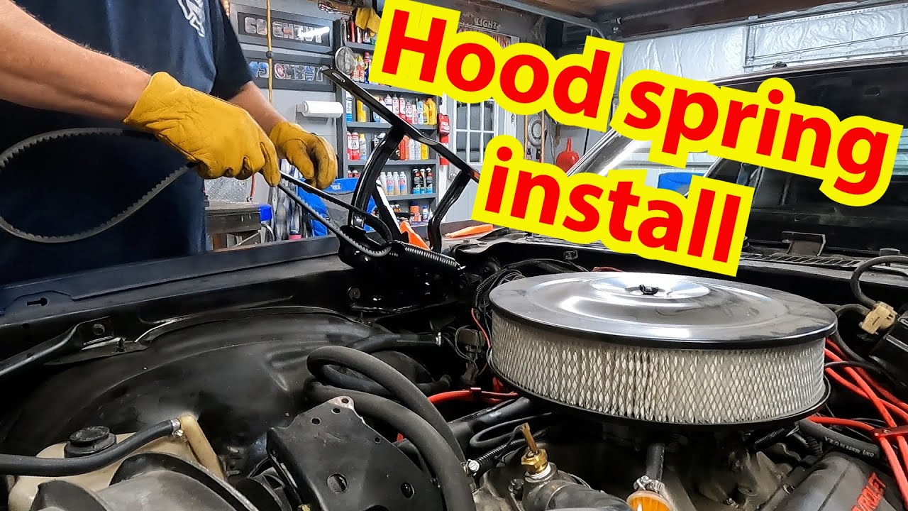 New hood springs and hinges are installed on the 80 Chevy Camaro.