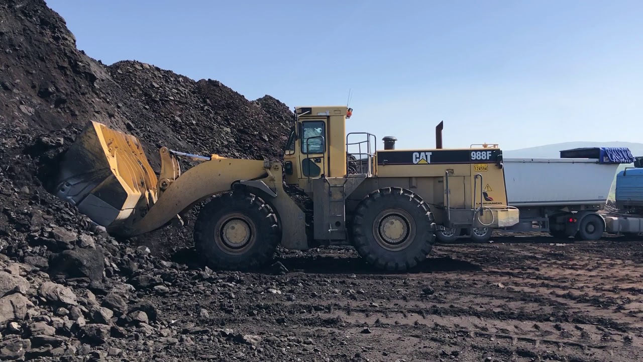 Caterpillar 988F Wheel Loader Loading Coal On Trucks