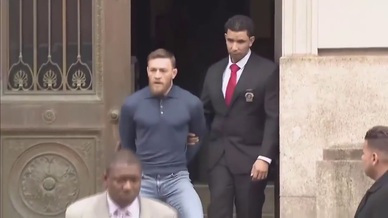 Conor McGregor is removed from the police station in handcuffs and was escorted to the court