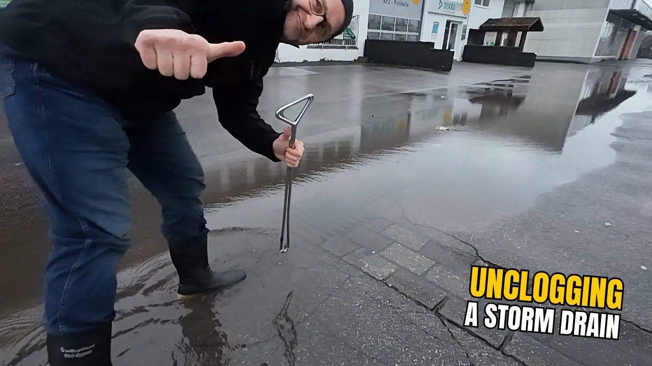 #064-2 Unclogging a storm drain on a parking space after rain in Germany