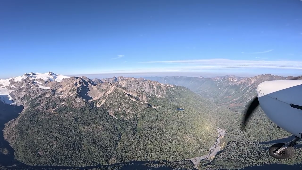 Cessna 150J Robin flying over Olympic Mountains