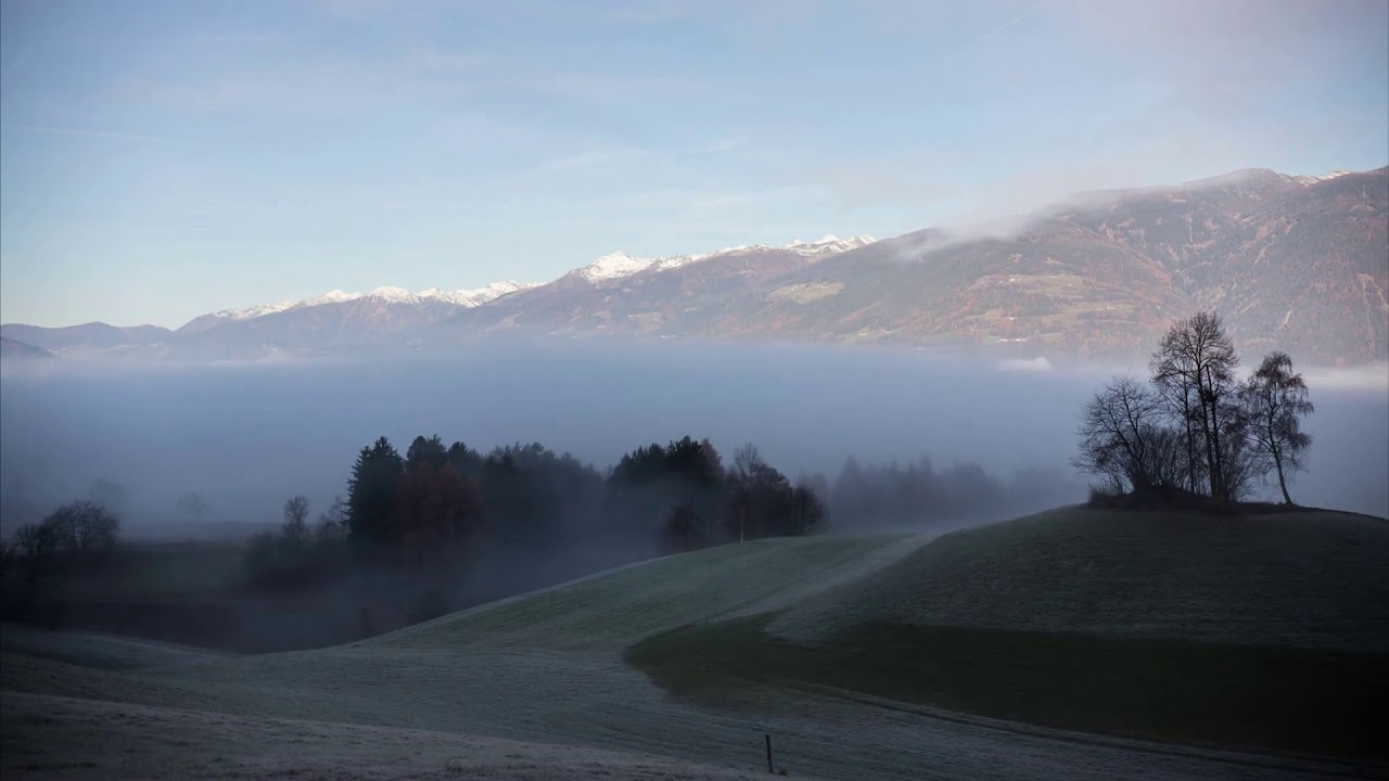 dolomites mysterious landscape foggy overcast weather low white clouds timelapse