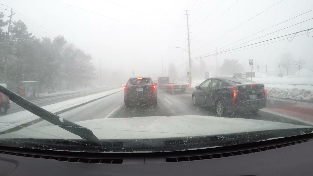 Driving on Steeles Avenue admit snow storm. Toronto, Canada , Jan 2026