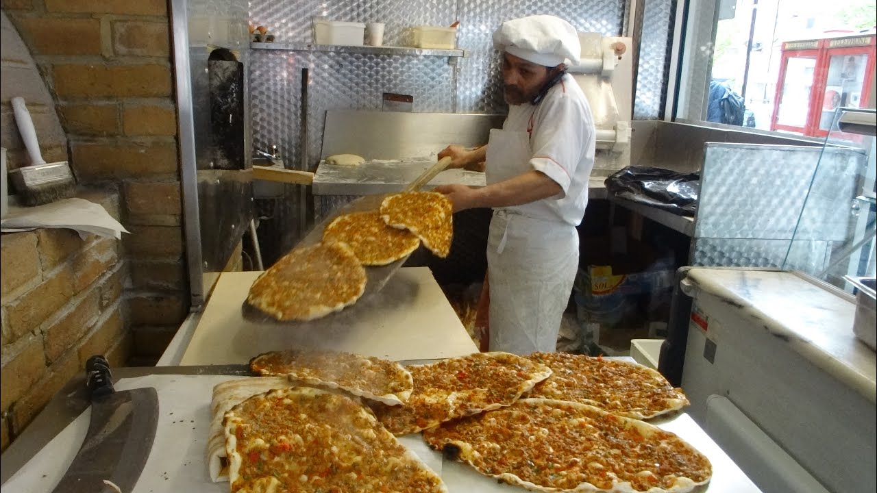 Master Baker Gino making Turkish Flat Bread Pizza (Pide) and Lamachun in a wood fired oven, London.