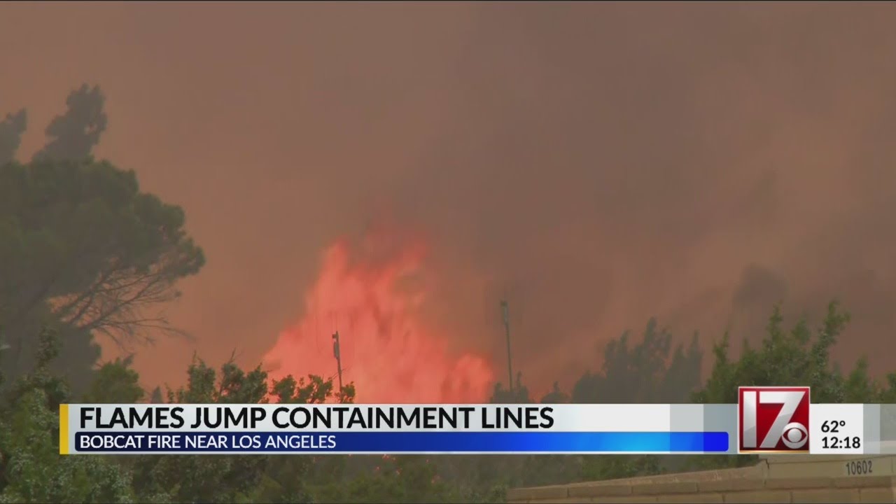 Wildfire flames jump containment lines in California
