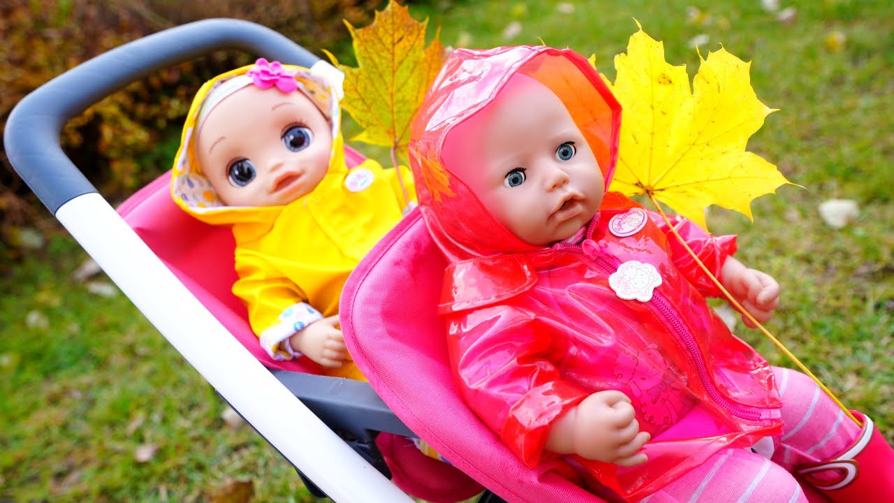 Baby Annabell doll & Baby Alive doll can't share rainy boots and a raincoat before going for a walk.