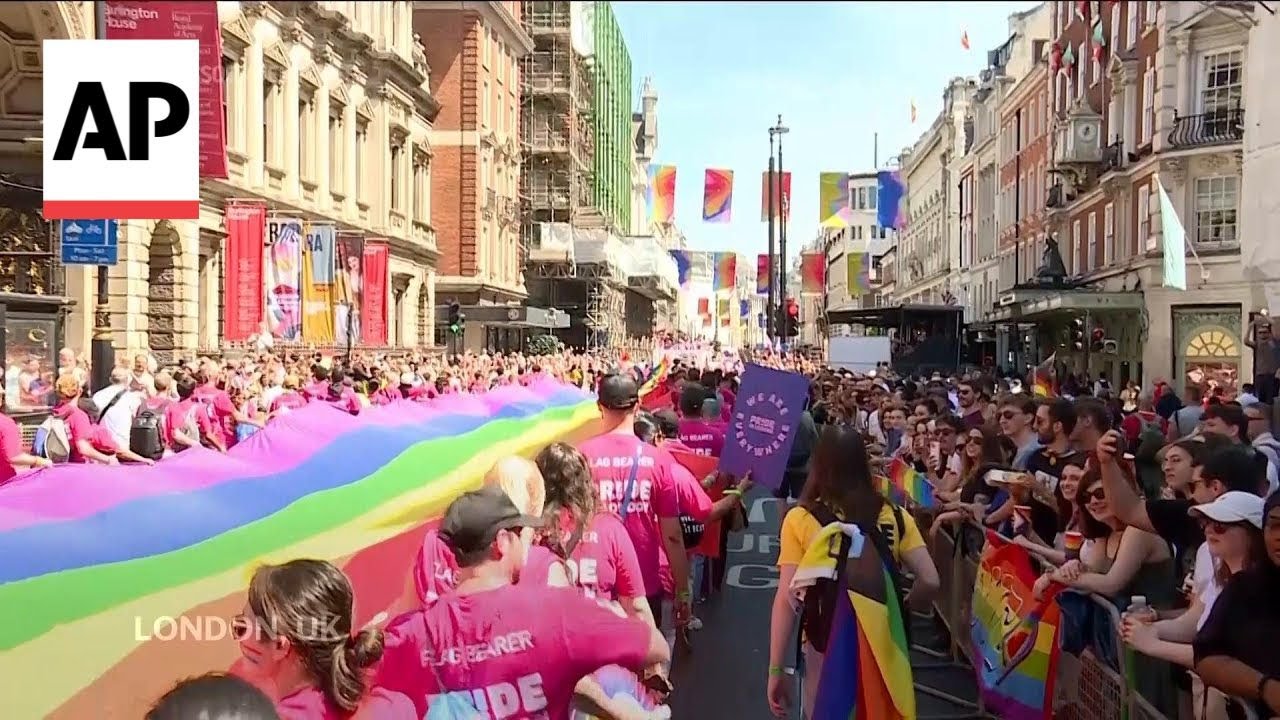 Sun shines on tens of thousands of revellers joining annual Pride parade in central London