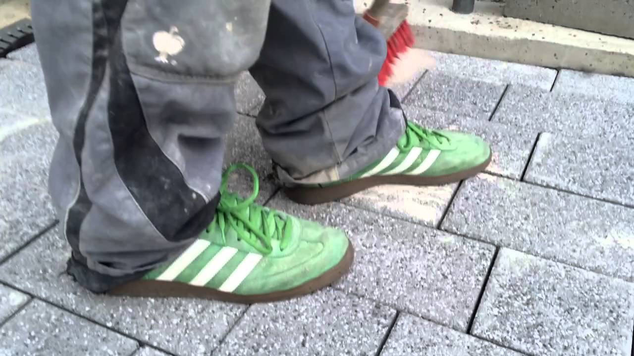 Worker with smelly ADIDAS Sneakers in sand
