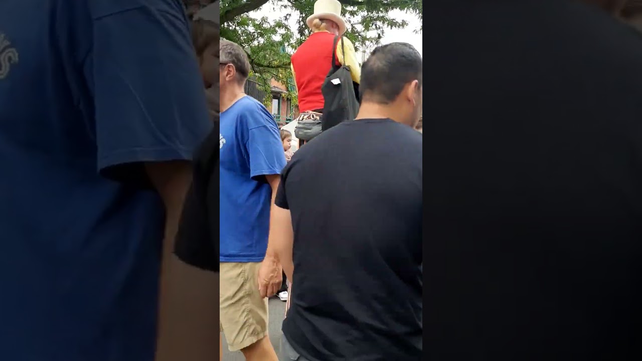 It's hard enough for women to walk on high heels. And he is making balloon for people in street .