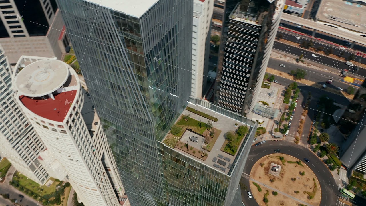 High angle view of tall modern glass cover building. Drone camera flying around Paradox Torre