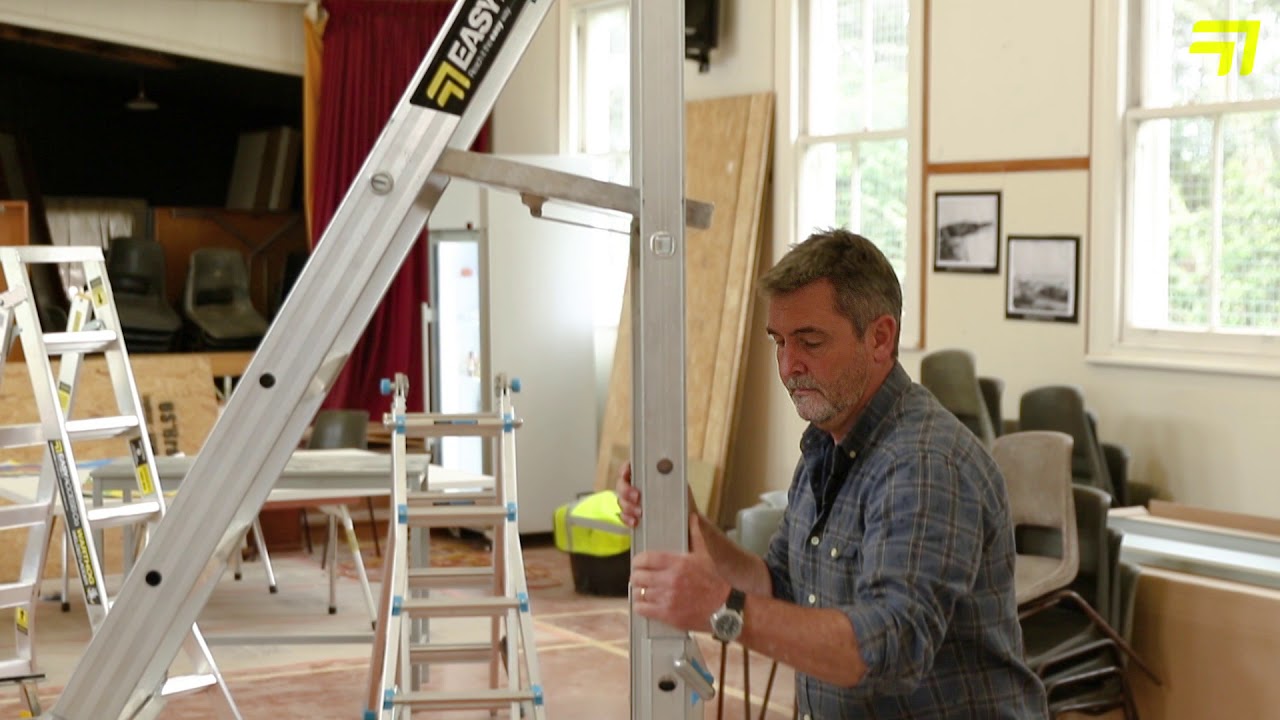 RESIDENT BUILDER PETER WOLFKAMP DEMONSTRATES THE EASY ACCESS ADJUSTASTEP LADDER