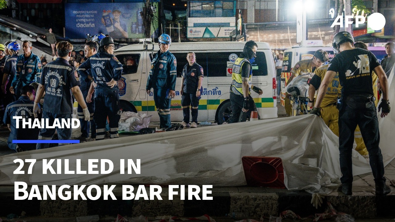 Emergency services remove bodies of people who died in bar fire in Bangkok | AFP