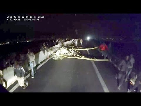 CALAIS: Migrants block Road, ambush and attack Truck Driver for UK passage 720p 30fps H264 192kbit
