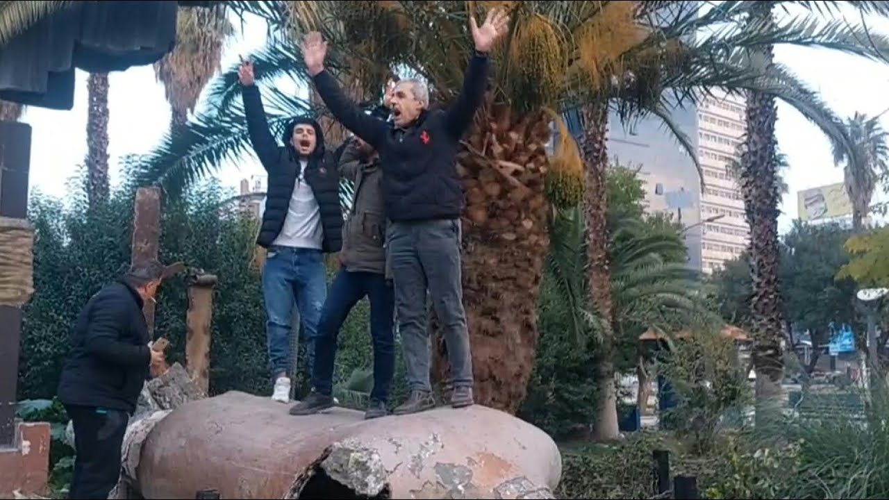 Syrians in Damascus deface statue of Hafez al-Assad | AFP