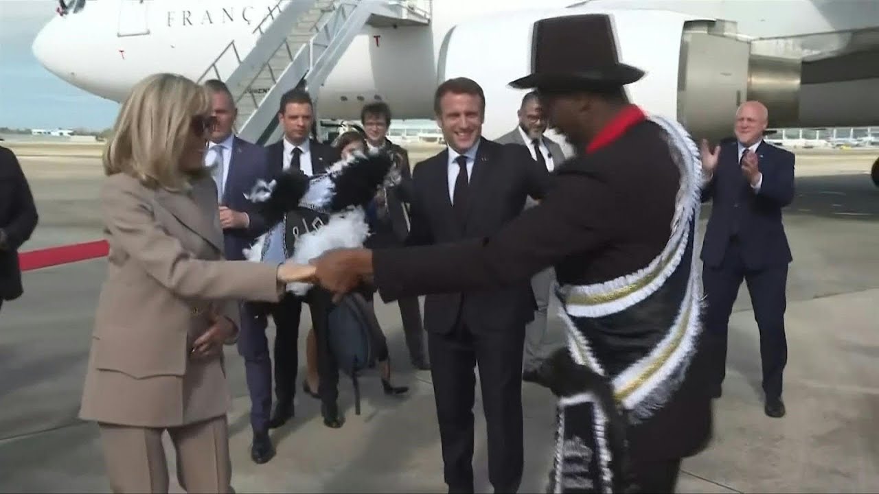 French President Macron dances as he arrives at the airport in New Orleans | AFP